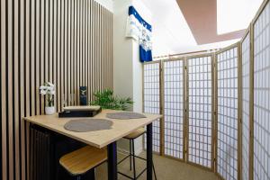 a room with a table with two stools in it at Zen Love Room Jaccuzzi Sauna in Pontivy
