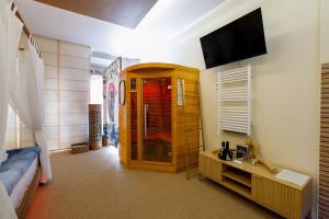 a bedroom with a bed and a television in a room at Zen Love Room Jaccuzzi Sauna in Pontivy