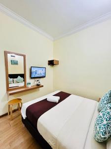 Postel nebo postele na pokoji v ubytování CHARISMA HOTEL