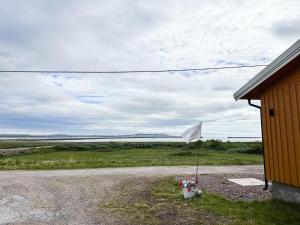 a white umbrella sitting on the side of a building at Svartbakken Rooms in Vardø