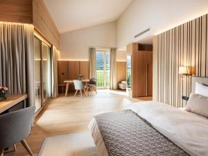 a hotel room with a bed and a table and chairs at Schloss & Boutique Hotel Mitterhart in Schwaz