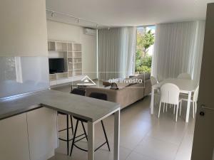 a kitchen and living room with a table and a couch at Green Coast 60b - by Ale Investa in Palasë