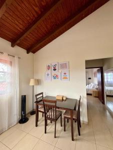a dining room with a table and chairs and a bedroom at Casita Catiri - Cozy Guesthouse with a Pool in Noord
