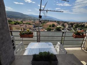 a table and chairs on a balcony with a view at Bellavista Monolocale in Foligno