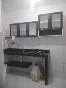 a bathroom with a black sink and three mirrors at Chalé Brisa do Mar in Santa Cruz Cabrália