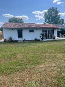 a house with a lawn in front of it at Maison cosy in Ambarès-et-Lagrave