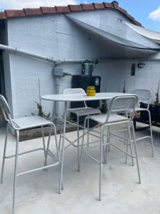 a white table and chairs on a patio at Maison cosy in Ambarès-et-Lagrave