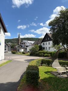 a set of stairs in a town with a church at Haus Einruhr in Simmerath