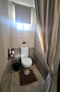 a bathroom with a white toilet in a room at Lala Panzi in Ghanzi +7 photos