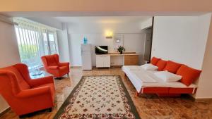 a living room with a couch and two chairs at Hotel Lido in Mamaia