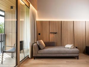 a living room with a couch and a chair at Schloss & Boutique Hotel Mitterhart in Schwaz