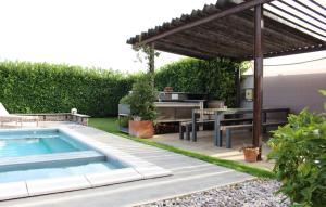 a backyard with a swimming pool and a pergola at Family Dream Dalmatia - Split by Villas Guide in Košute
