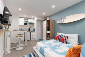 a bedroom with a bed and a surfboard on the wall at La Cabane du Surfeur in Clermont-Ferrand