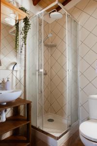 a shower in a bathroom with a toilet and a sink at Aldeia Caiçara Surf House in Sagres +37 photos