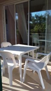 アルガジョラにあるRésidence Beau rivageの白いテーブルと白い椅子2脚