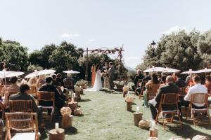 a bride and groom walking down the aisle during their wedding ceremony at Los Pilares de Ronda Boutique & Hotel in Ronda +37 photos
