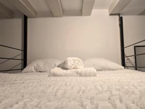 ein weißes Bett mit einem ausgestopften Tier darüber in der Unterkunft le rêve suspendu in Le Mans