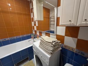 a bathroom with a washing machine and a mirror at Three Bedroom Stepana Bandery Street in Rivne +54 photos