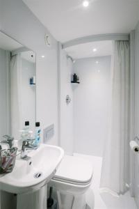 a bathroom with a sink and a toilet and a mirror at Waddell Hall, University of Cumbria in Lancaster