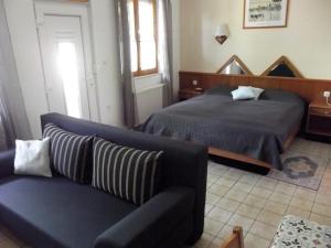 a bedroom with a bed and a couch at Remser Haus in Zalakaros +12 photos