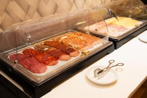 a plastic container with meat and other food on a table at Hotel Puerta del Mar - Adults Recommended in Nerja
