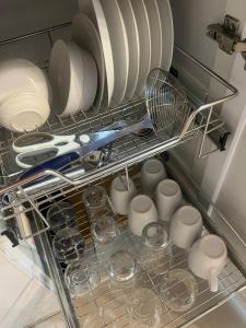 a drawer filled with dishes and plates and a strainer at Skyview 2BR at Grass in Manila
