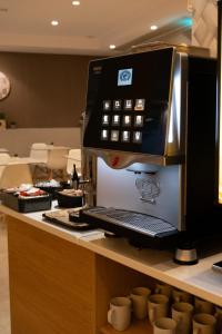 a coffee machine sitting on top of a counter at Hotel Puerta del Mar - Adults Recommended in Nerja