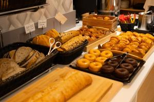 a buffet of different types of bread and pastries at Hotel Puerta del Mar - Adults Recommended in Nerja