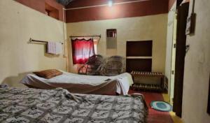 a room with two beds and chairs in it at Agnihotri Tourism Centre in Machhrehta