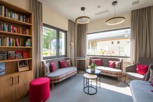a living room with two couches and a book shelf at Hostel by Randolins in St. Moritz
