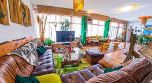 a living room with leather couches and a television at Estate - Villa Discovery in Ljubuški