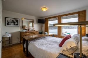a bedroom with a bed with a desk and a mirror at Iconic Battery Cottagesignal Hillsea&city Views in St. John's