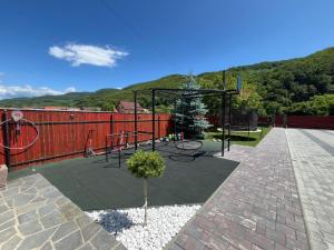 a patio with a play area with a playground at Dió vendégház in Praid