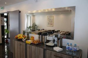 a kitchen with a counter with a coffee maker at Luxor Bastille Hotel in Paris