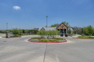 a building with a roundabout in the middle of a street at Blueground Austin pool nr Walnut Creek Park ATX-260 in Austin