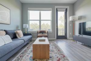a living room with a blue couch and a coffee table at Blueground Austin pool nr Walnut Creek ATX-258 in Austin