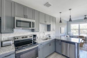 a kitchen with white cabinets and a stove top oven at Blueground Austin pool nr Walnut Creek ATX-258 in Austin