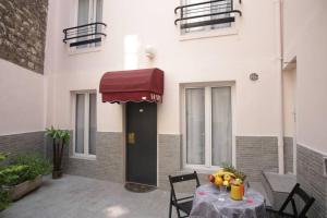 a table with fruit on it in front of a building at Luxor Bastille Hotel in Paris +31 photos