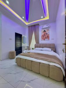 a bedroom with a large bed with a purple ceiling at luxury 3bed rooms duplex lekki Lagos nigeria in Lekki