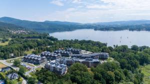 an aerial view of a resort on a lake at Laguna Beskidów Resort - Apartament Podhalański in Zarzecze