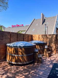 two large wooden barrels on a patio with a wooden fence at Sava Dream СПА-мотель in Zhytomyr +113 photos