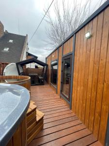 a wooden deck with a hot tub on a house at Sava Dream СПА-мотель in Zhytomyr