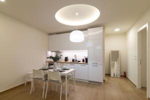 a kitchen with a table and chairs in a room at Elea in Mytilene