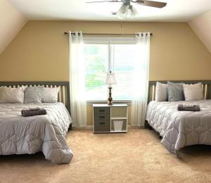 a bedroom with two beds and a window at 2-story family pool home in Oxford, 30 min to ATL in Oxford +30 photos
