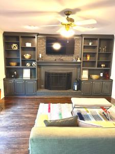 a living room with a fireplace and a couch at 2-story family pool home in Oxford, 30 min to ATL in Oxford