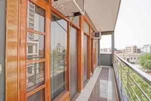 a balcony of a building with a view of a city at HOTEL O THE VIRAAT in Noida
