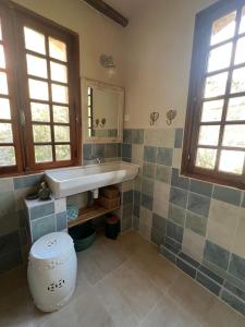 a bathroom with a sink and a toilet at To a Book House in Corsica - chambres d'hôtes in Oletta