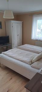 a large white bed in a room with a window at Seeblick Krippenstein2 in Obertraun