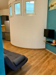 a living room with a couch and two windows at Edelweiss Apartments in Villach +15 photos