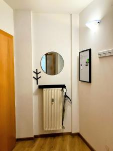 a room with a radiator and a mirror on a wall at Edelweiss Apartments in Villach